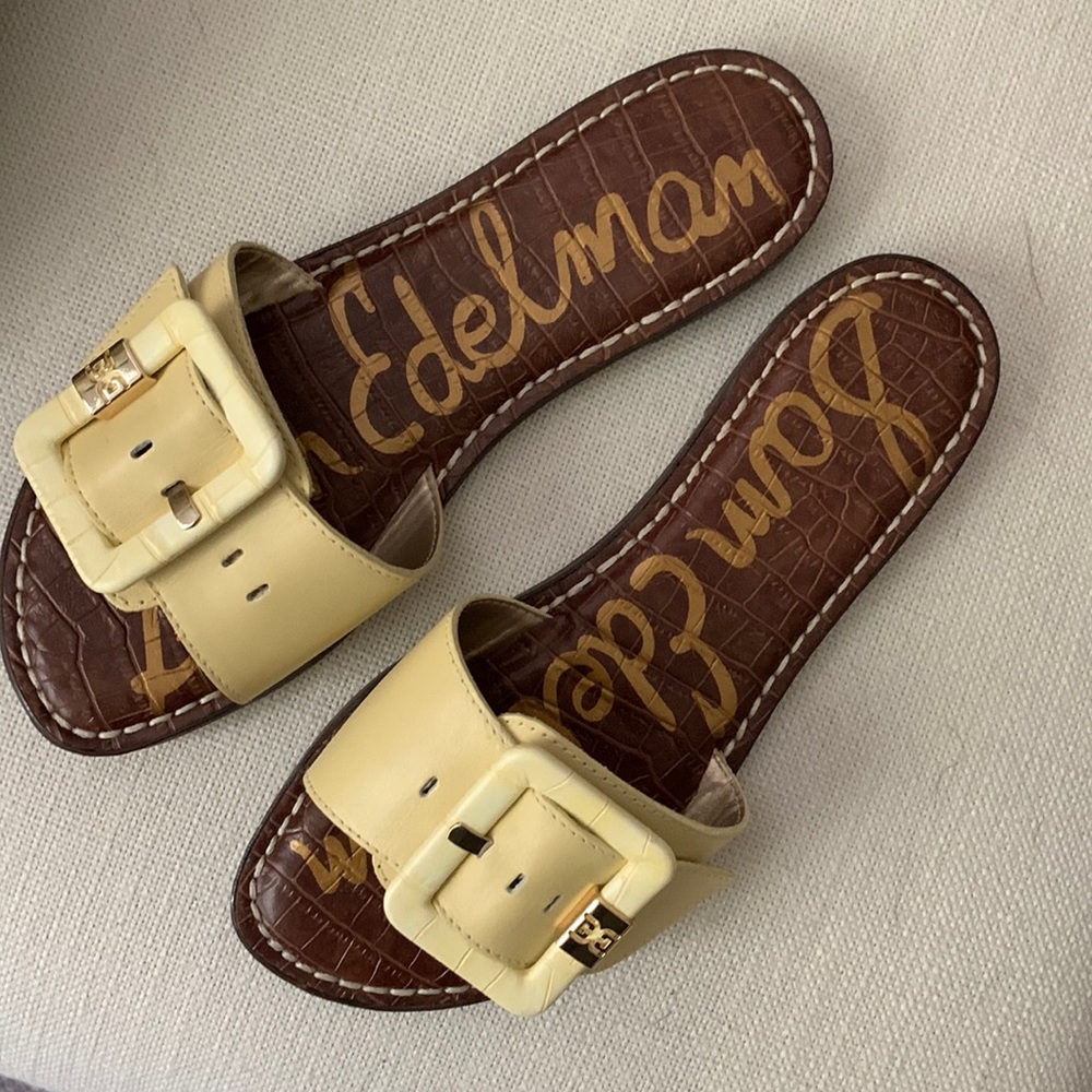 Pale yellow flat slide on sandals with adjustable buckle
